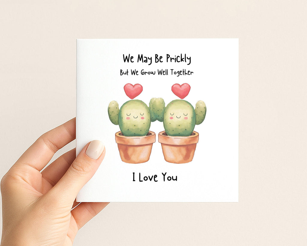 Close up of funny cactus couple card with small red heart details