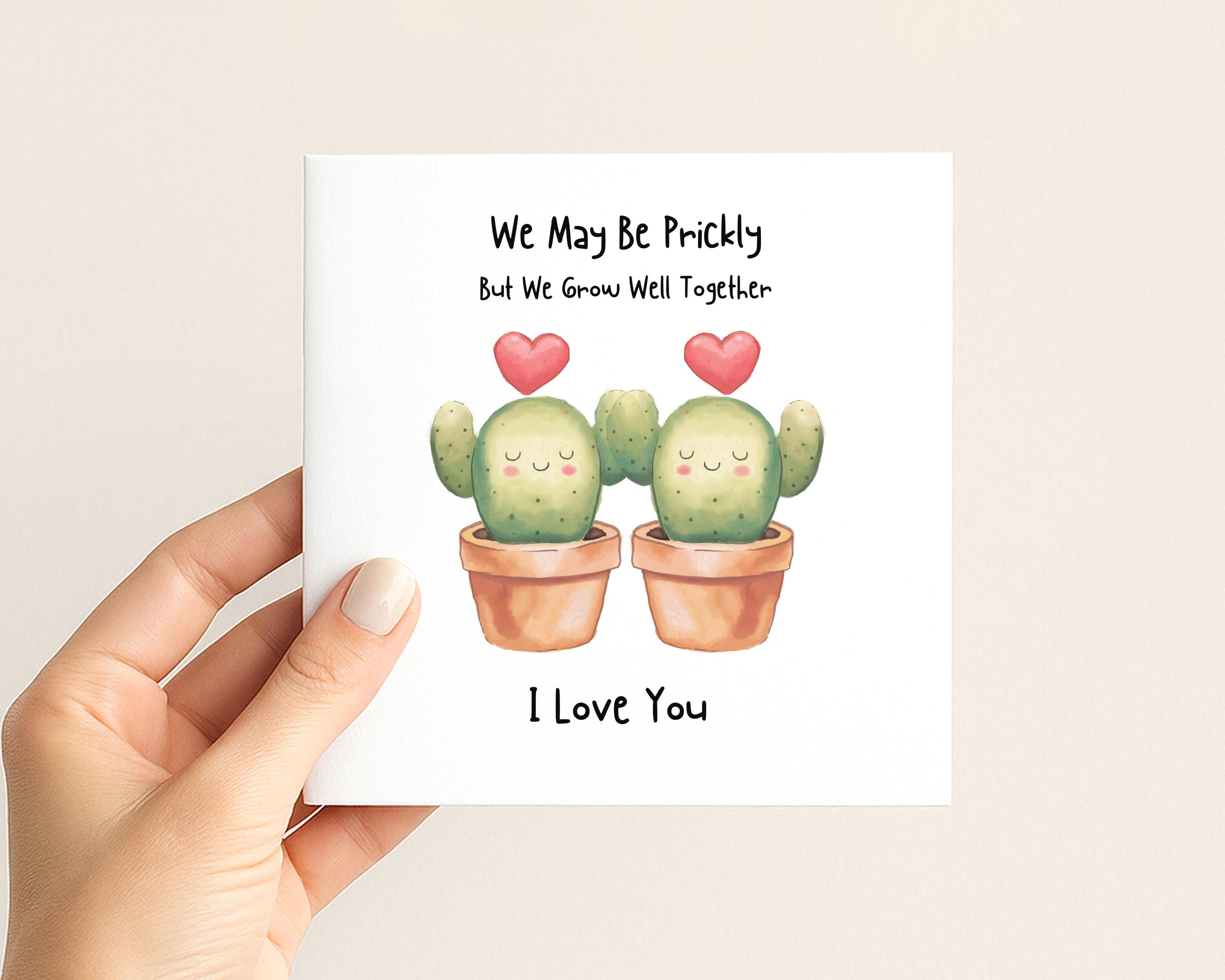Close up of funny cactus couple card with small red heart details